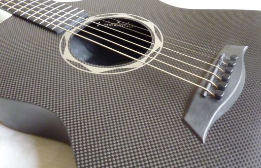 Dramatic weave of carbon fiber, a Wittman Mini tuner in the soundhole